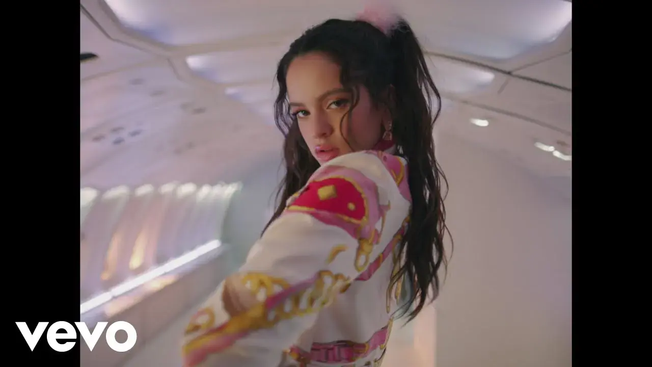 Rosalía looking over her shoulder inside a plane